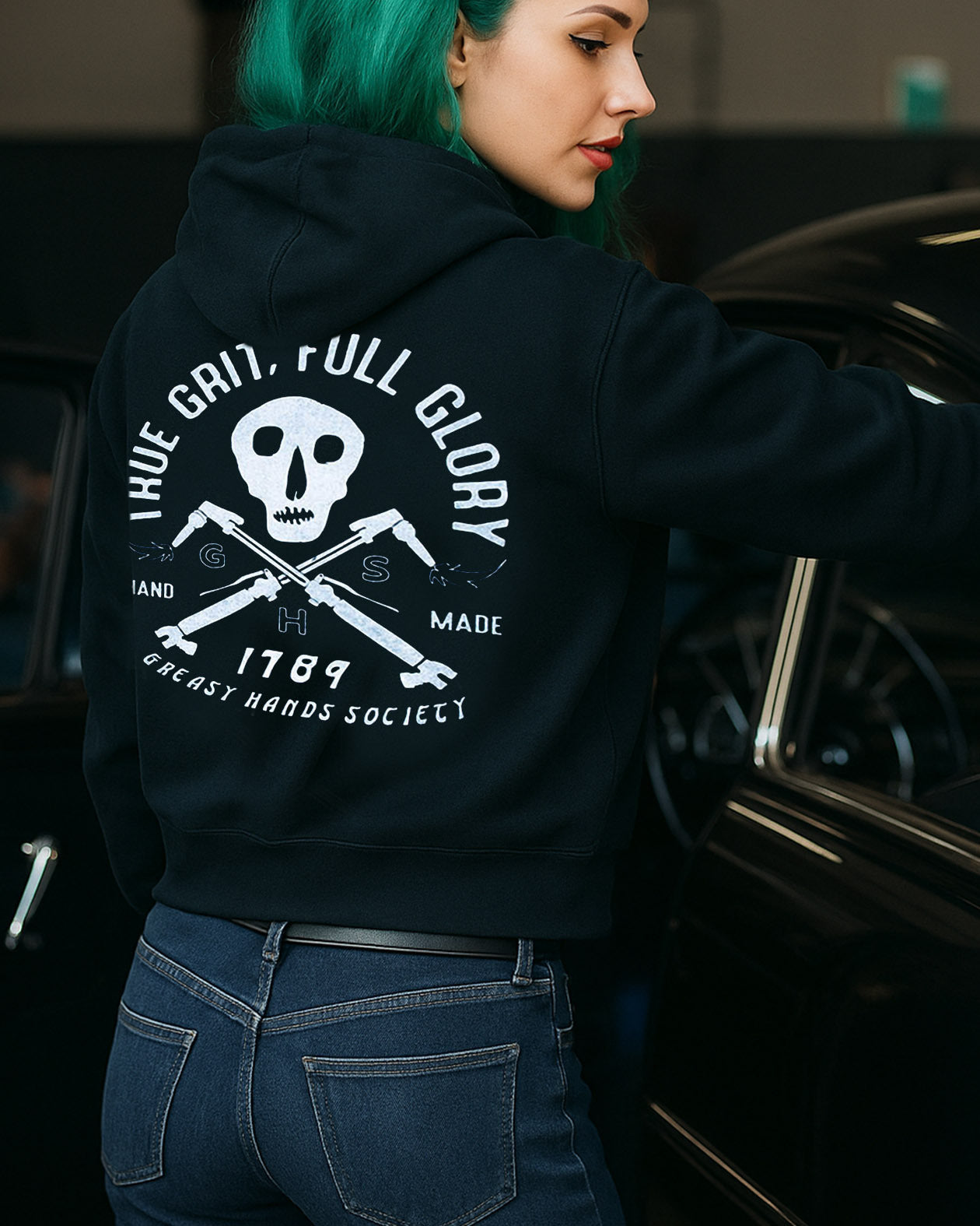 cutting it close black womens hoodie with a skull and crossed welding torches showing the words true grit full glory.